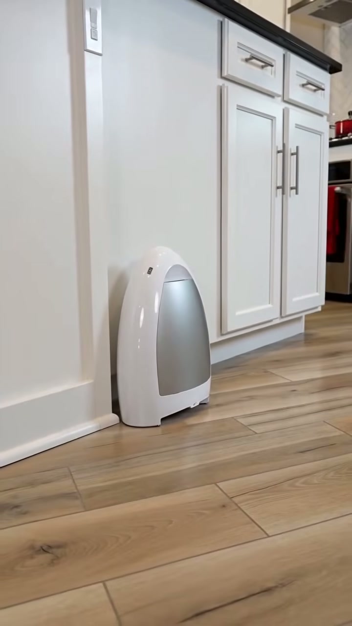 A motorised dustpan that lives against the kickboard