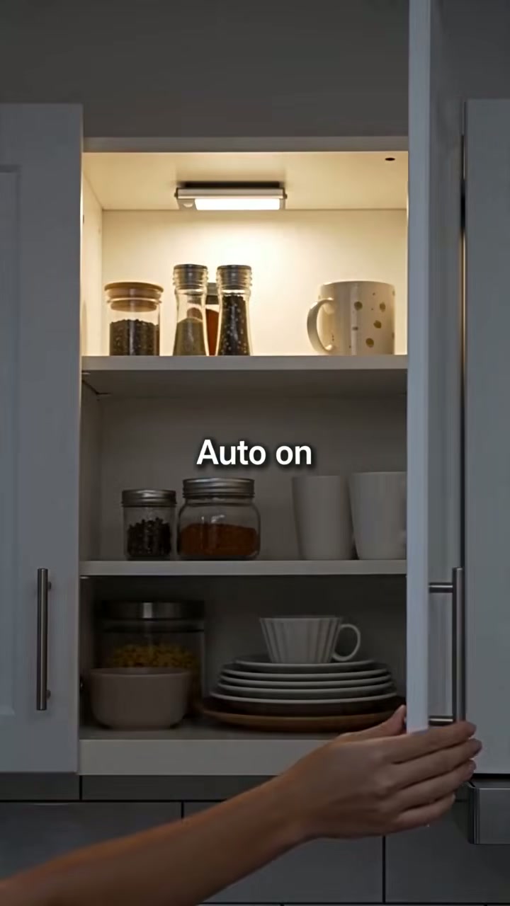 A rechargeable LED bar that lights a dark cupboard automatically